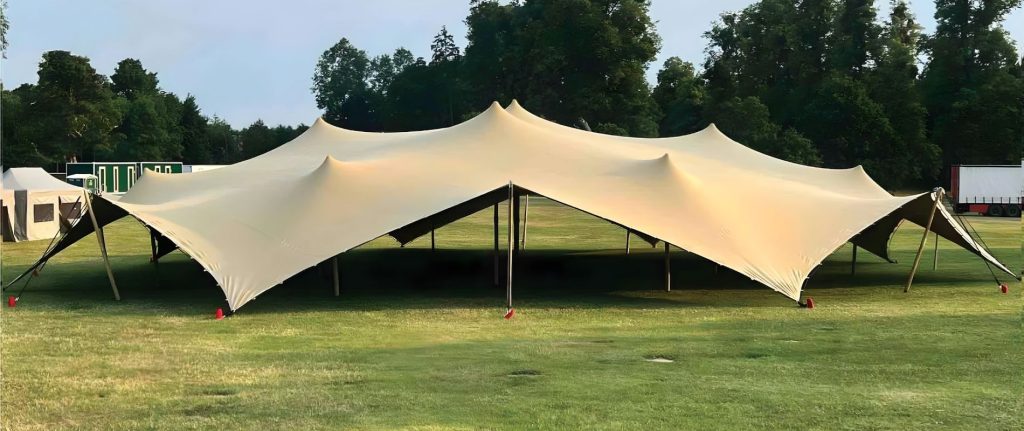 Cream stretch tent set up at golden hour